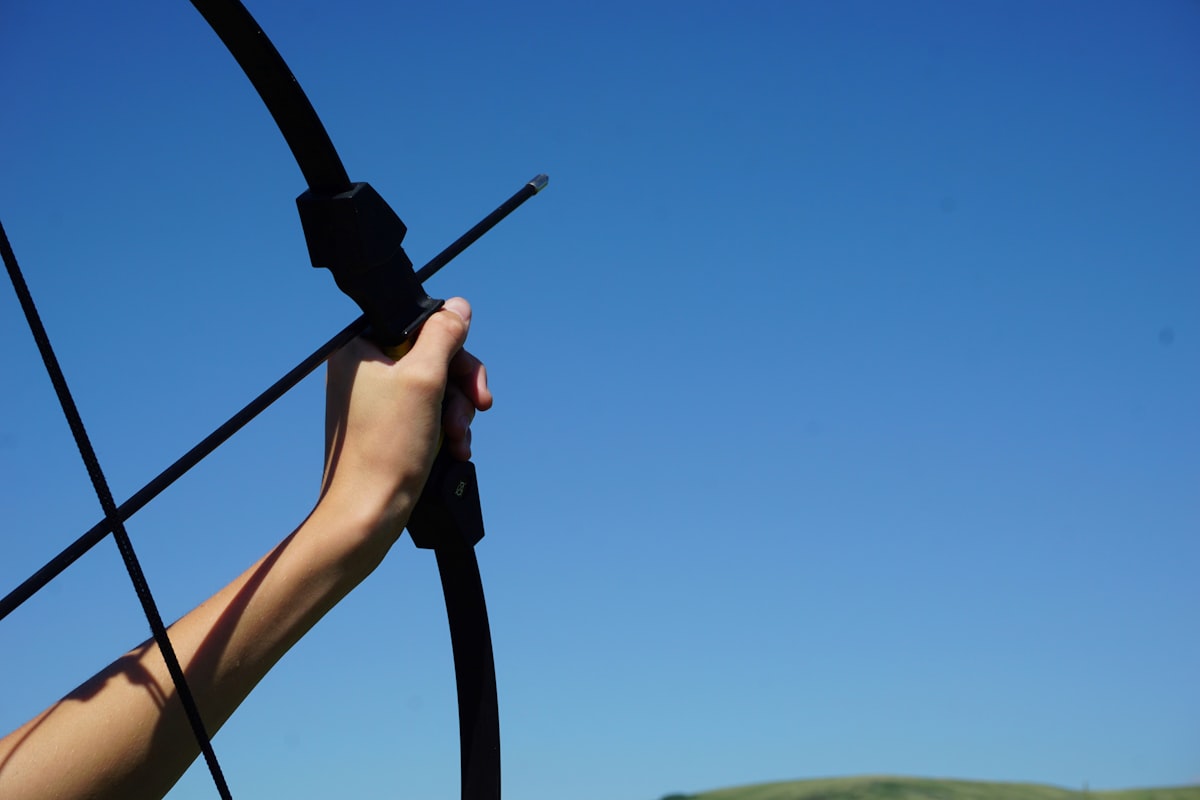 Gloved hand nocking an arrow on a bow